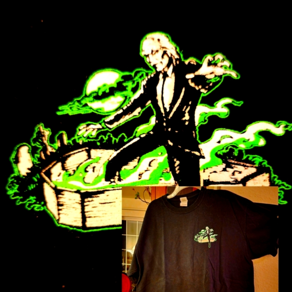NOVELTY TSHIRT ..Zombie in Graveyard  with his open grave I background